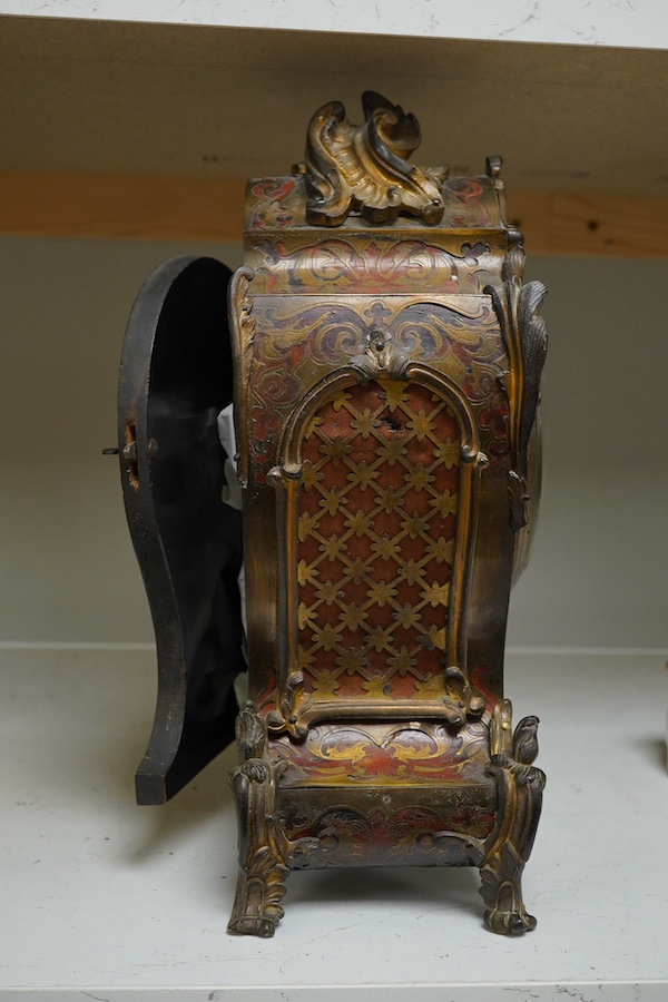 A 19th century Boulle work mantel clock with enamelled Roman numerals, with pendulum and key, 34cm high. Condition - fair, untested